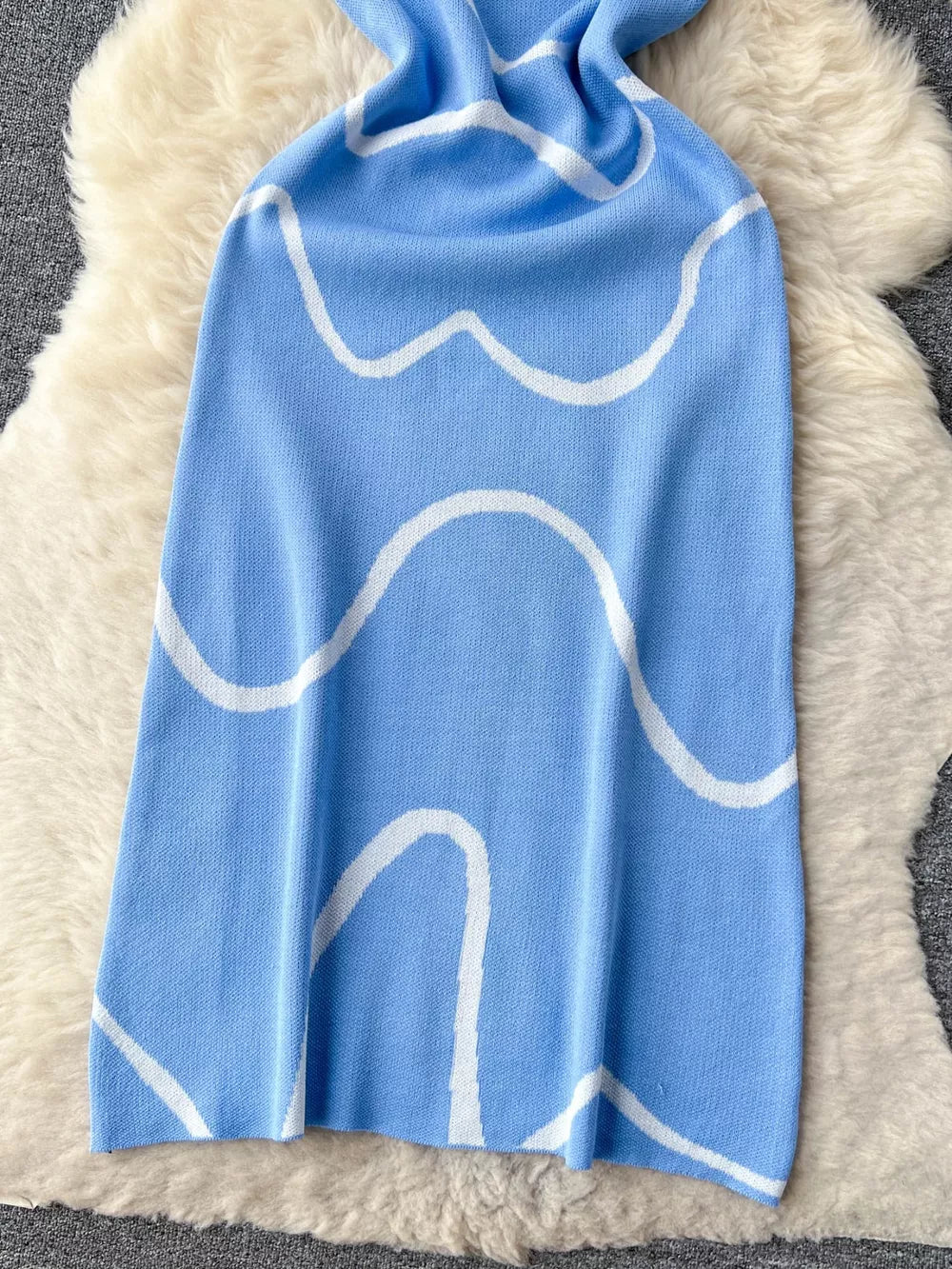 Blue wavy knit midi dress with spaghetti straps and white abstract pattern