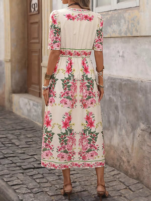 Cream midi dress with pink floral print, V-neck, short sleeves, and defined waist.