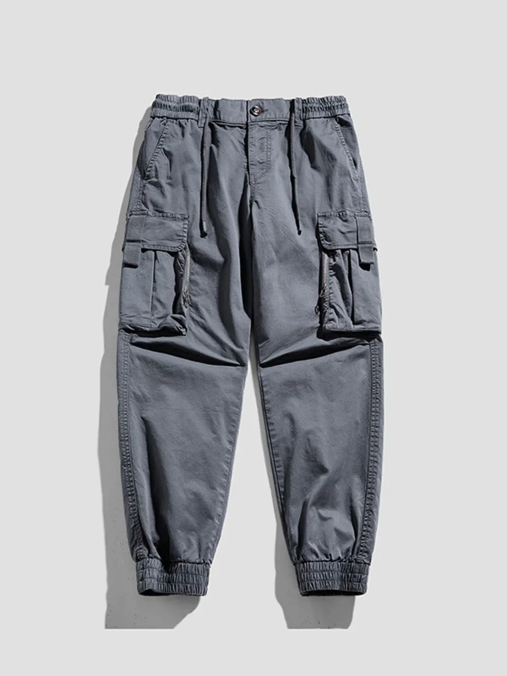 Gray cargo joggers with flap pockets and elastic cuffs.