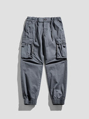 Gray cargo joggers with flap pockets and elastic cuffs.