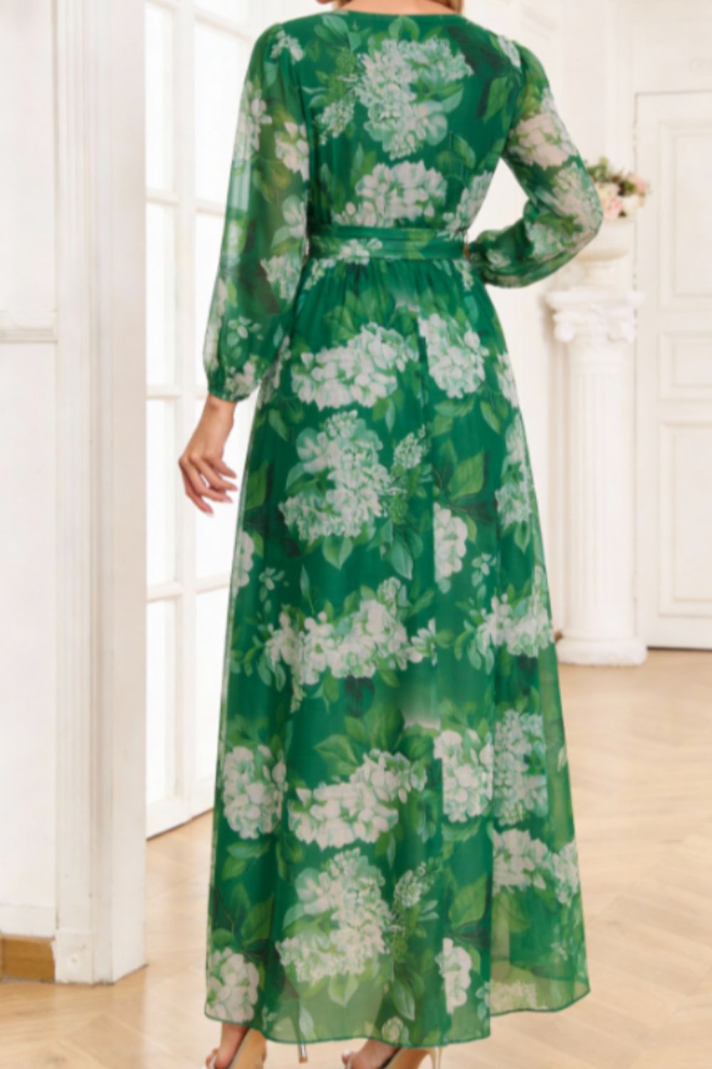 Green floral print maxi dress with tied waist and long sleeves.