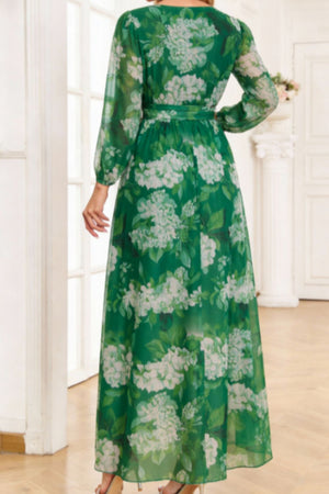 Green floral print maxi dress with tied waist and long sleeves.