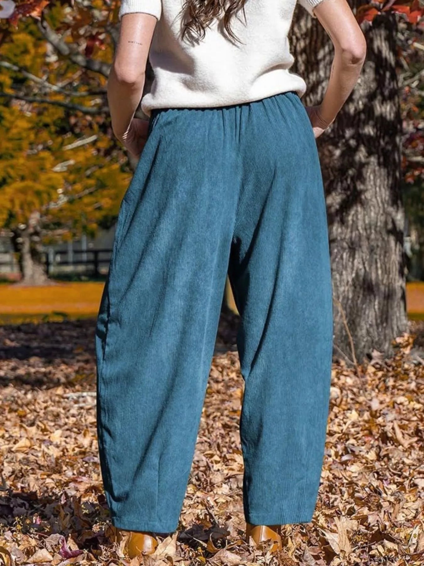 Blue wide-leg corduroy pants with pockets and an elastic waistband.