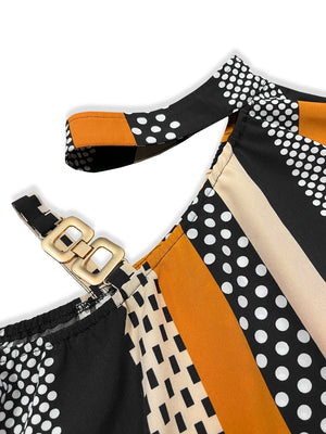 Asymmetric stripe shoulder top in black with gold buckle detail and mixed patterns.