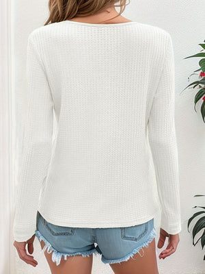 White waffle knit henley shirt with natural buttons, long sleeves, and a casual fit.