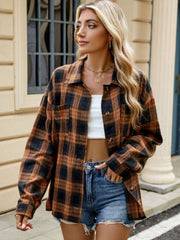 Brown and black plaid collared long sleeve shirt with buttoned front and chest pockets.