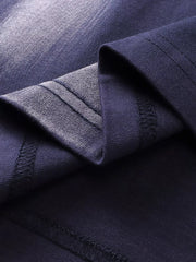 Men's dark navy t-shirt with abstract brushstroke detail and visible stitching.