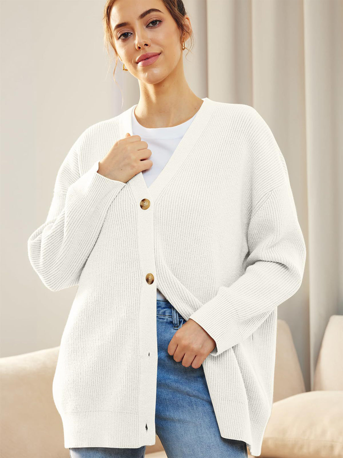 White ribbed knit cardigan with balloon sleeves and button front.