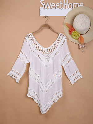 White crochet V-neck cover-up with chevron detail and fringe sleeves.