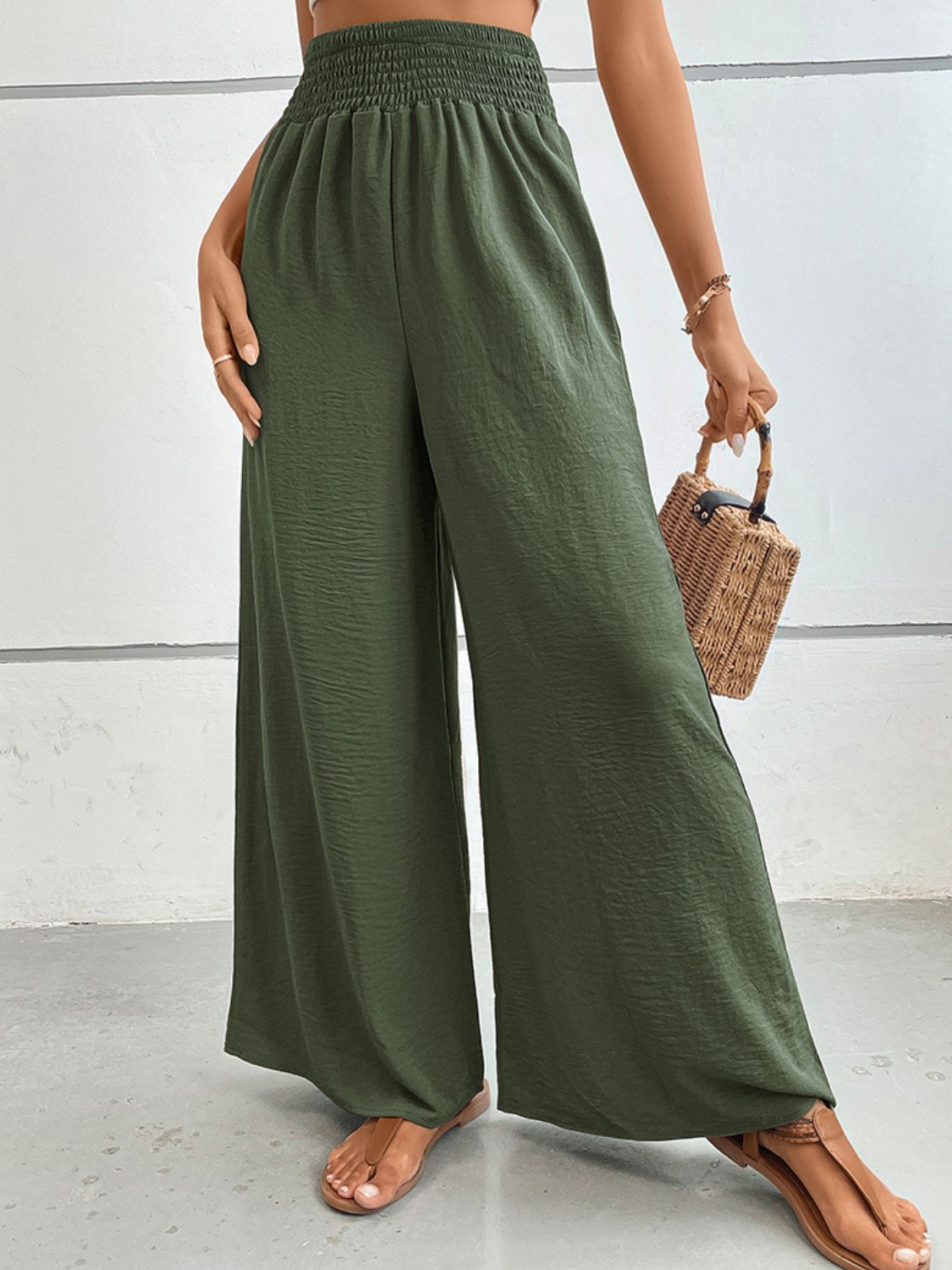 Matcha green textured smocked waist palazzo maternity trousers with wide legs.