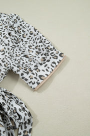 Print button-down midi dress with short sleeves and leopard pattern.