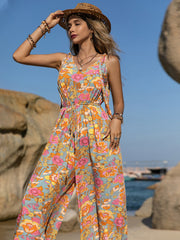 Bohemian floral tie-strap jumpsuit with v-neck and wide legs.