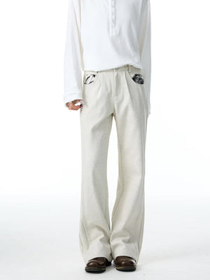 Men's ivory wide-leg trousers with patterned pocket details