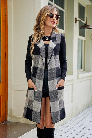 Longline plaid vest in black and grey acrylic with pockets and a notched collar.