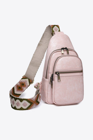 Blush pink sling bag with geometric strap and multiple zip pockets