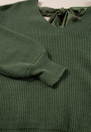 Dark green ribbed knit sweater with a V-neck and satin bow tie back detail.