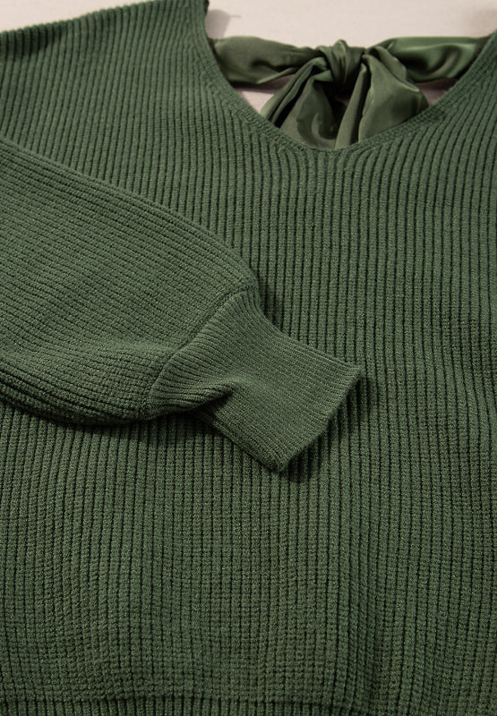 Dark green ribbed knit sweater with a V-neck and satin bow tie back detail.