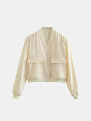 Cream utility pocket bomber jacket with button front and ribbed cuffs.