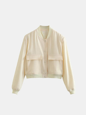 Cream utility pocket bomber jacket with button front and ribbed cuffs.
