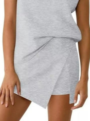 Light gray asymmetrical skort with a layered detail and side slits.