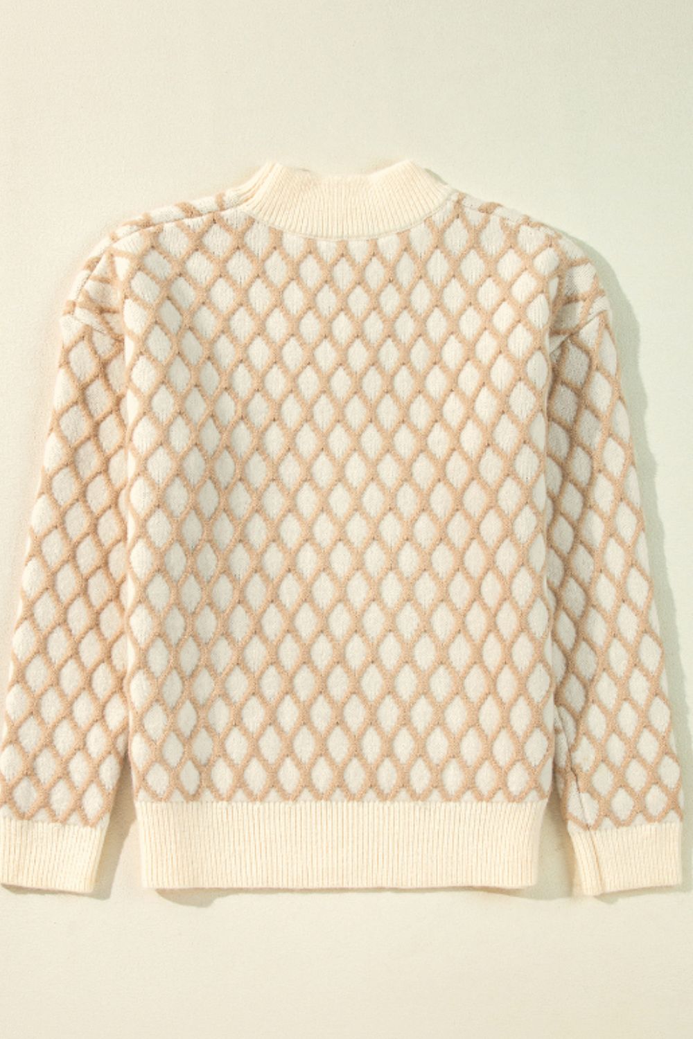 Diamond knit sweater in cream with balloon sleeves and a mock neck.
