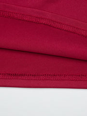 Red fitted one-shoulder t-shirt detail showing fabric texture and stitching.