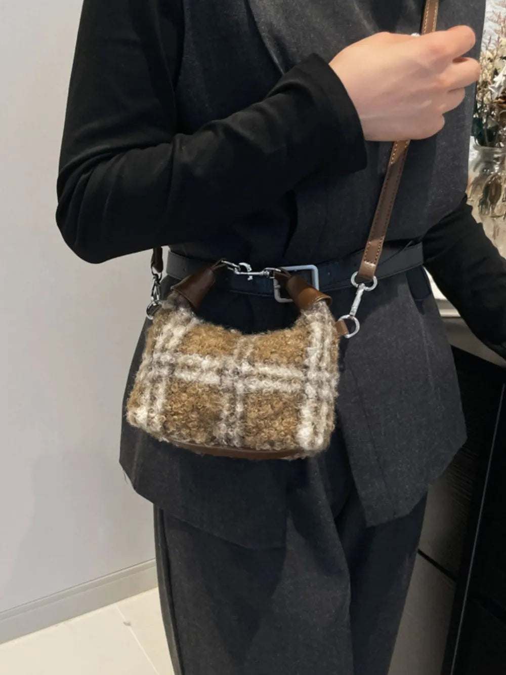 Shearling check mini shoulder bag with leather trim and strap.