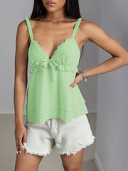 Green layered cami with lace trim, ruffled neckline, and bow detail.