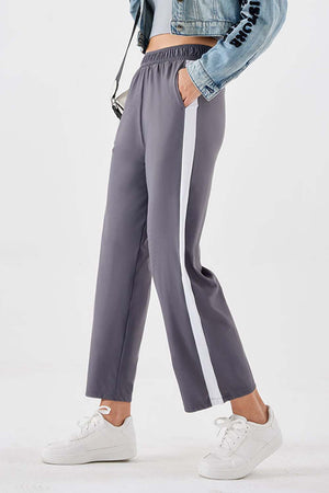 Charcoal relaxed trousers with white side stripe detail and elastic waistband.