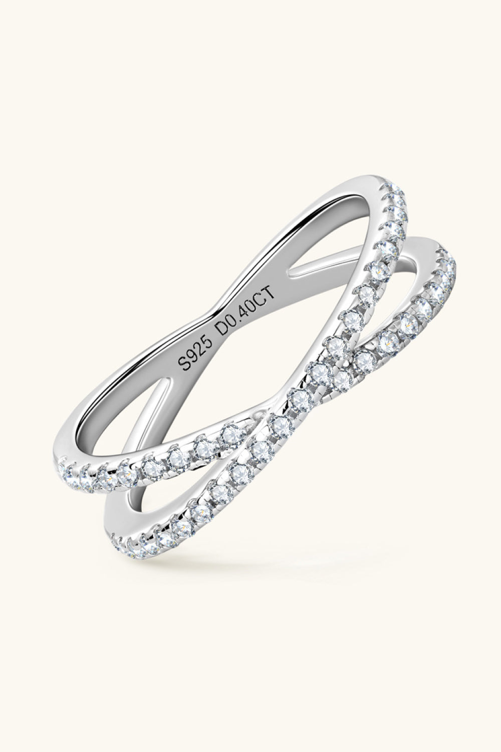 Silver pavé crossover band ring with cubic zirconia accents.