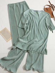 Elegant pleated two-piece set in olive green with short sleeves and wide-leg pants.