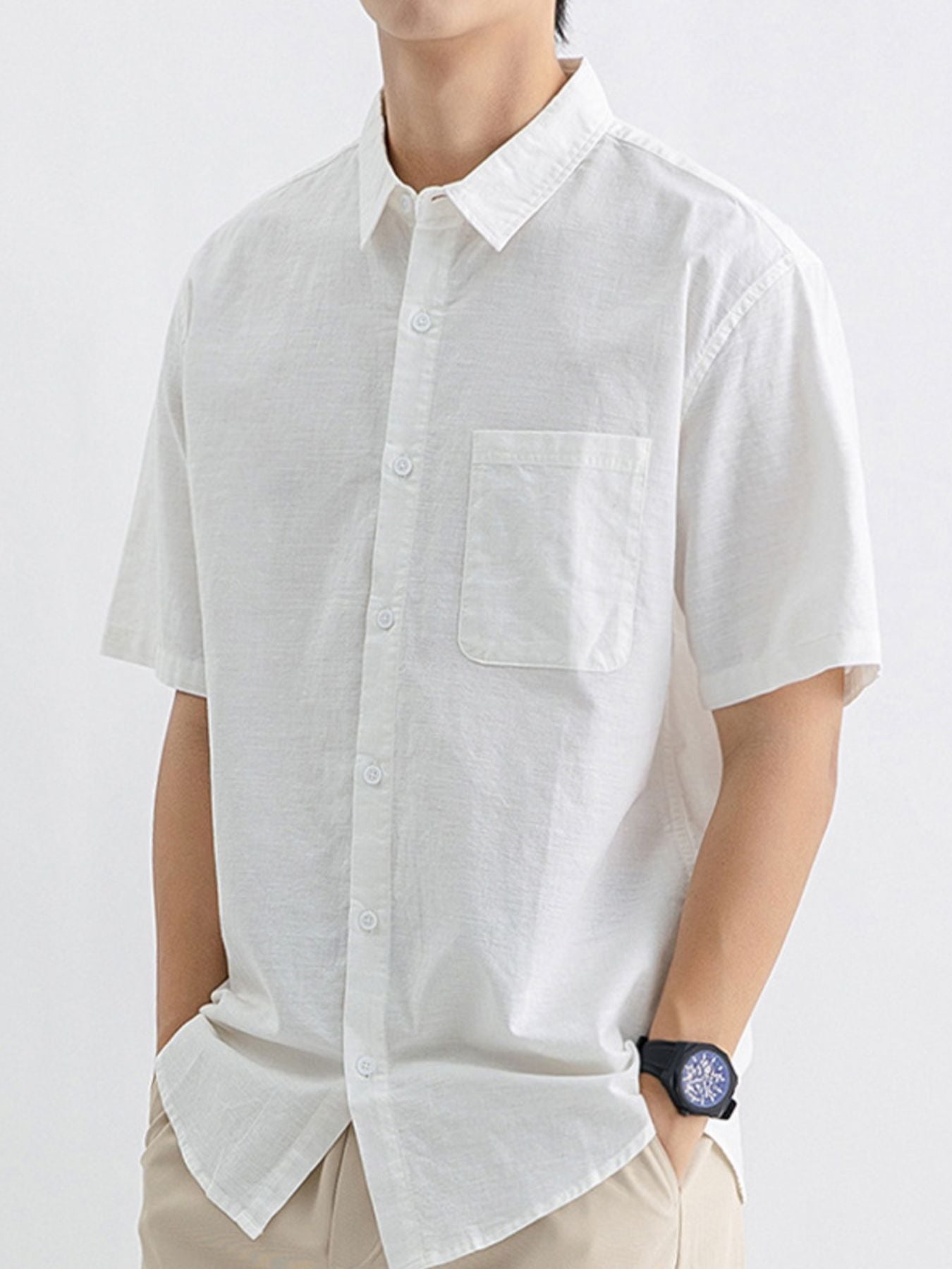 Men's white short sleeve button-up shirt with chest pocket and spread collar