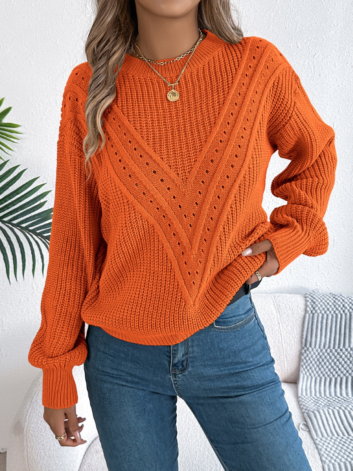 Orange chevron knit sweater with eyelet detail and crew neck.