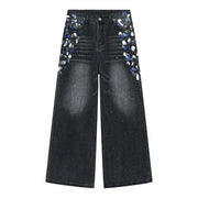 Dark wash wide leg jeans with painterly brushstroke details on pockets and legs.
