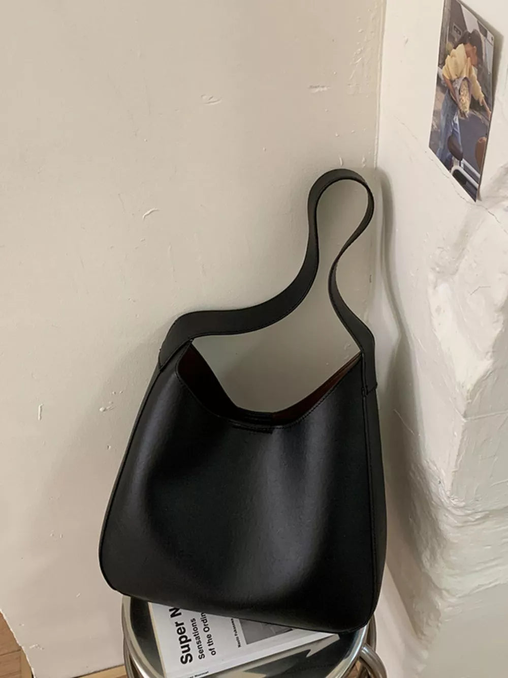 Sleek black large pu leather shoulder bag with a curved strap.
