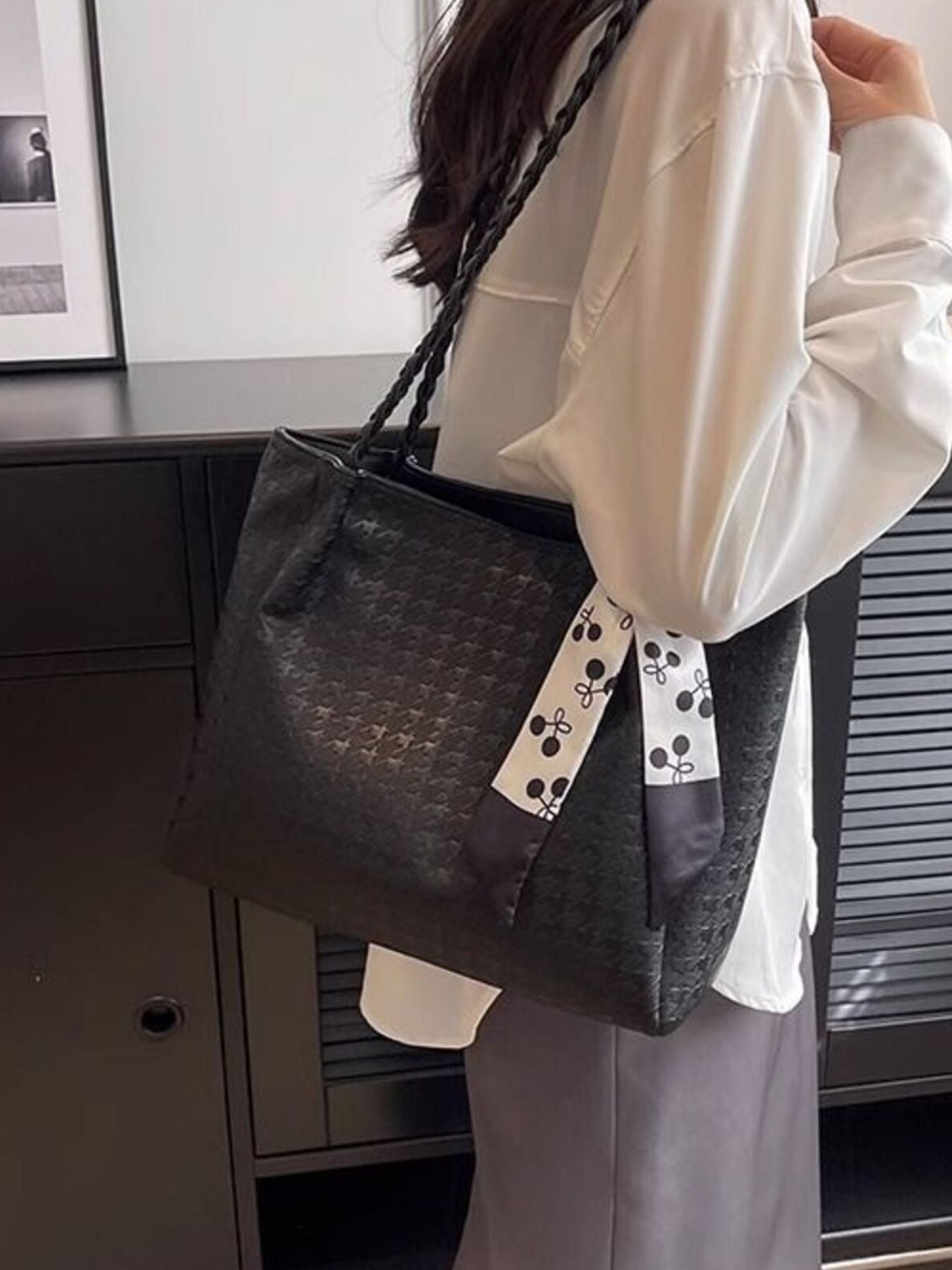 Black shopper bag with braided handle and cherry print scarf detail