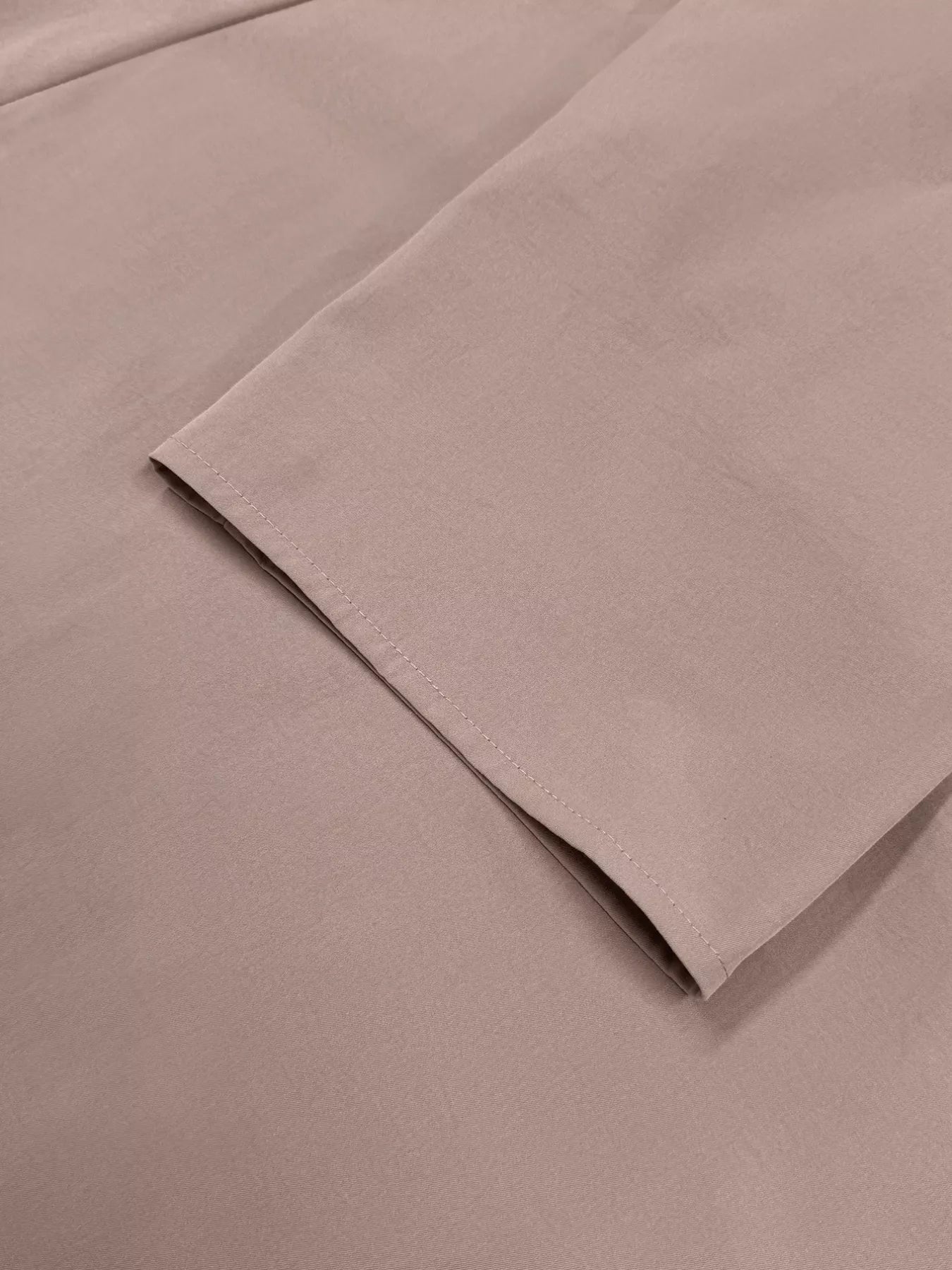 Dusty pink lightweight open front cardigan sleeve detail with clean stitching.