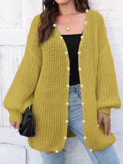 Yellow balloon sleeve cardigan with pearl buttons and open front.