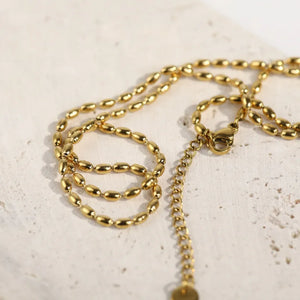 Gold capsule chain necklace with oval beads and adjustable clasp