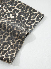 Denim shirt with leopard print, short sleeves, and a classic collar.