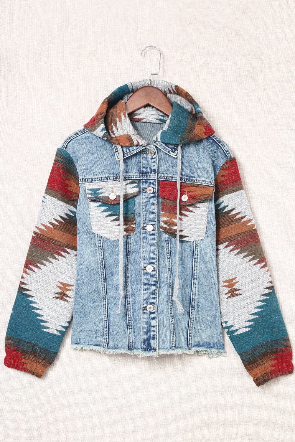 Denim hoodie jacket with Southwestern print on sleeves and hood, light blue wash cotton.