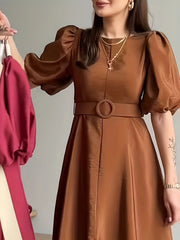 Brown belted midi dress with puff sleeves and a round buckle.