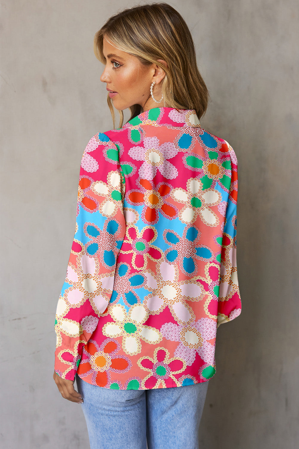 Multicolor floral print blouse with blouson sleeves and buttoned cuffs.