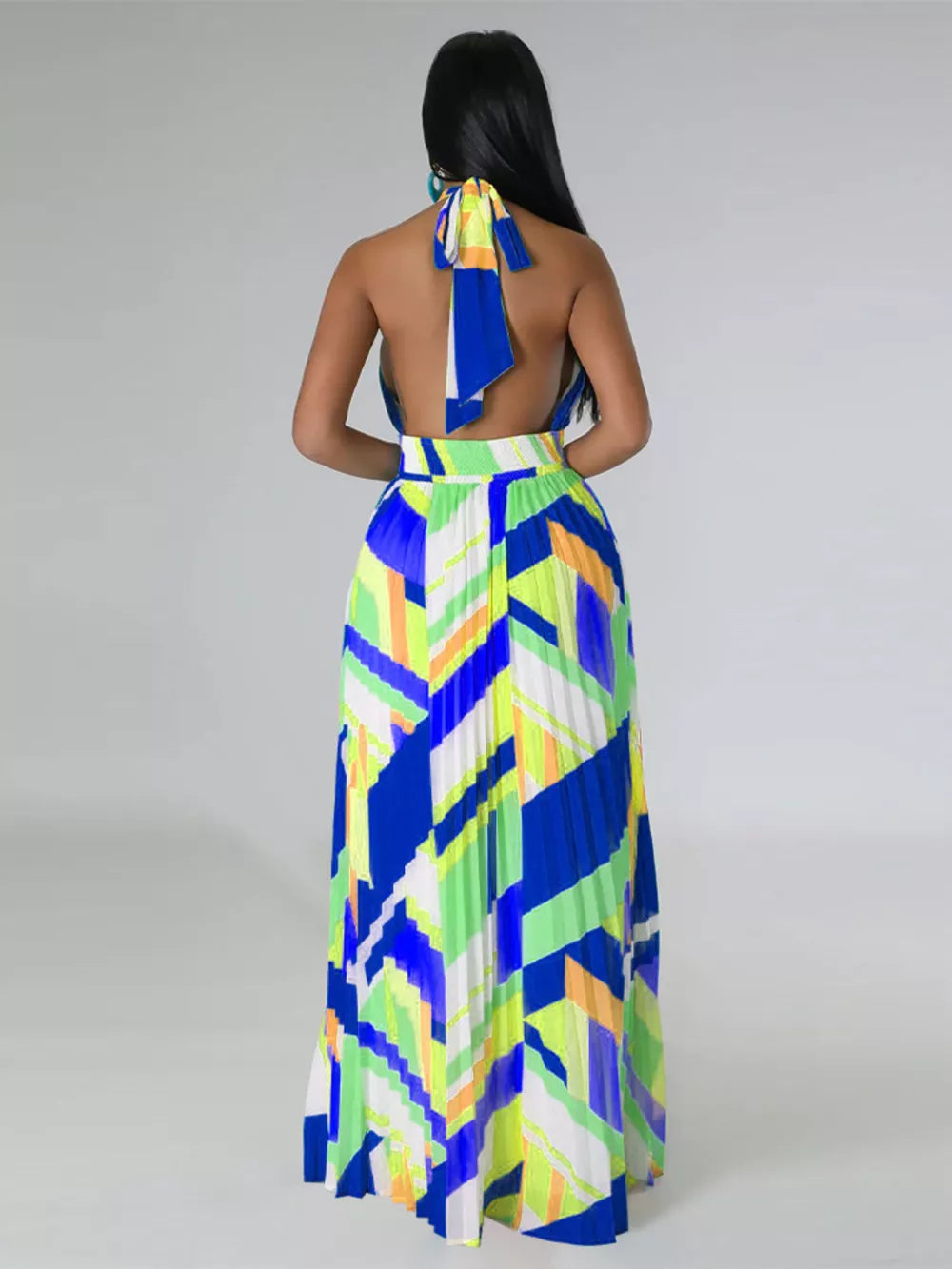 Halter neck maxi dress with geometric print and pleated skirt in blue, green, and yellow.