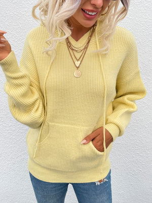 Yellow textured knit cocoon hoodie with drawstring hood and front pocket.