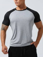 Raglan sleeve performance tee in light gray with black sleeves and neckline.