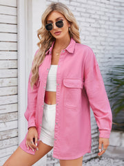 Pink oversized denim shirt with button front and chest pockets.