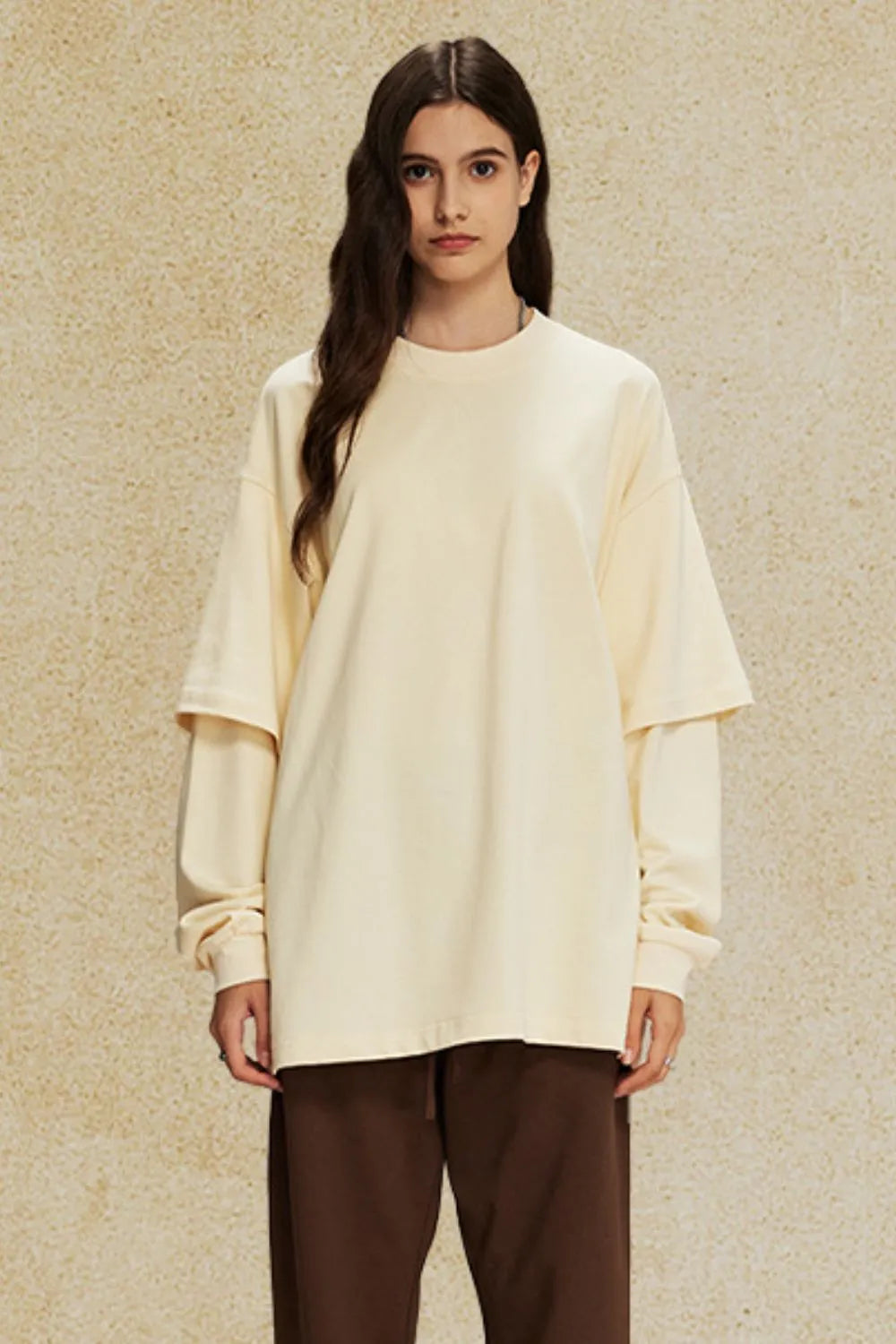 Beige layered sleeve oversized tee with crew neck and relaxed fit.