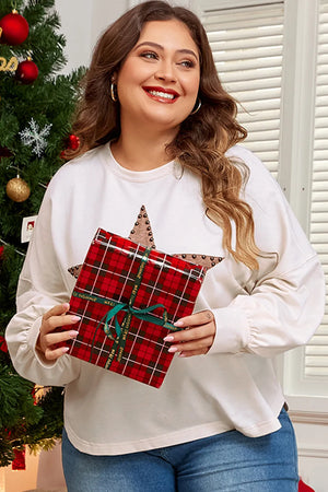 White sweatshirt with studded star detail and relaxed fit, holding a gift.