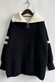 Black ribbed knit quarter-zip sweater with white collar and striped sleeves.